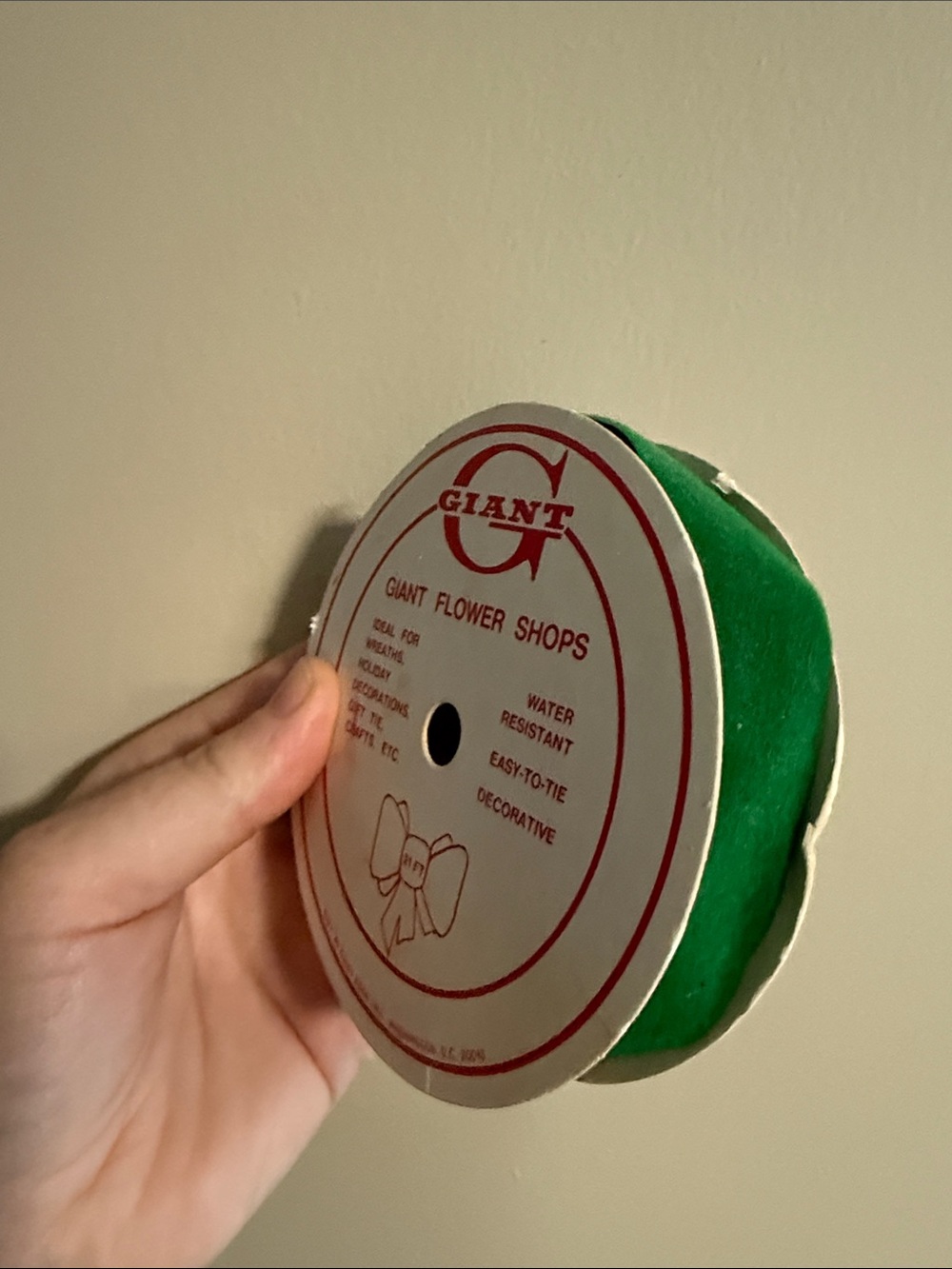 vintage spool of green floral and craft ribbon distributed by Giant
- used